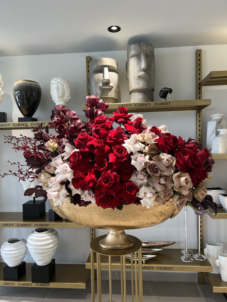 our Scarlet Serenity Floral Arrangement featuring red and burgundy orchids, quicksand and amnesia roses, and mini calla lilies. Front