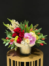 "Express love with Love Smile Arrangement – a masterpiece of red roses, tulips, orchids, and snaps. Perfect for V-Day, anniversaries, birthdays. Local GTA delivery, back