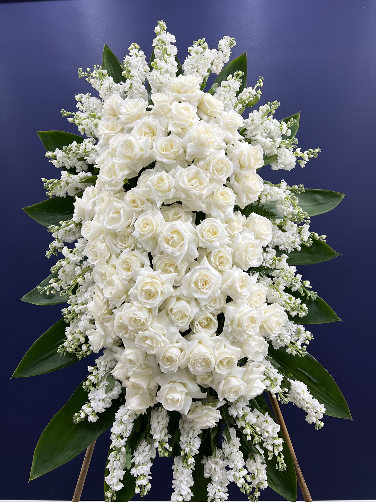 "Heavenly Rose Standing Spray: A Luxurious Tribute of Roses, Stocks, and Hydrangeas for Sympathy and Support. Elegant Flower Delivery by Yonge Florist to GTA Funeral Homes, Churches, and Chapels."