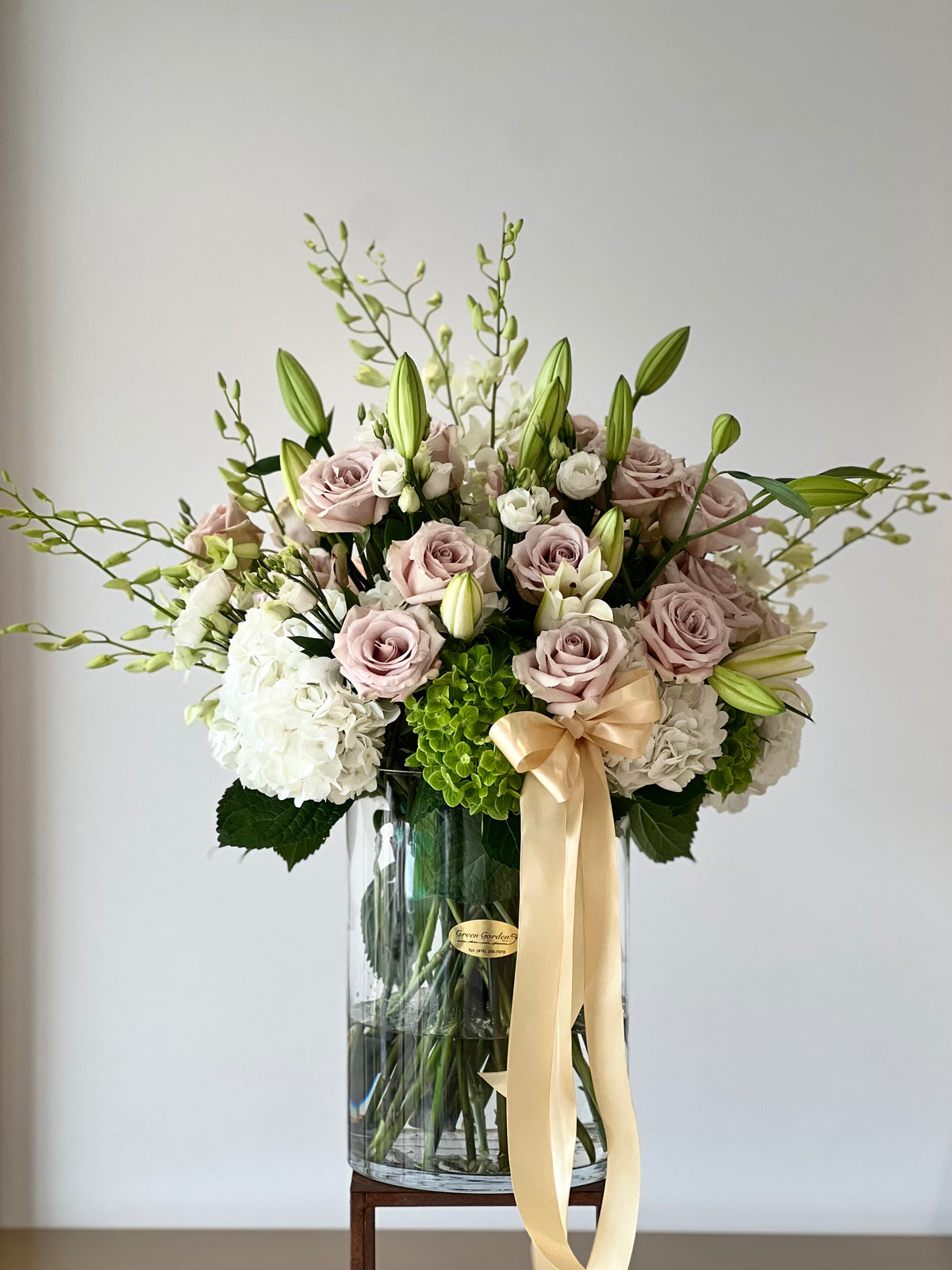 Sweet and Soft Floral Vase Arrangement: A soft and sophisticated blend of hydrangeas, roses, and orchids in delicate nude tones. Perfect for congratulating a new home, celebrating birthdays, or welcoming a new bundle of joy. Yonge Florist's expertly crafted bouquet with local and GTA flower delivery. 