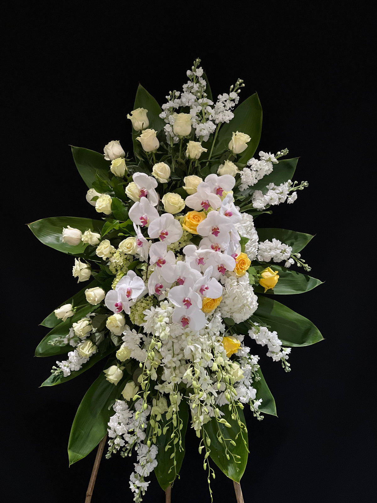 White and Yellow Funeral Standing Spray with Stocks, Roses, Hydrangeas, Dendrobium Orchids, and Phalaenopsis Orchids